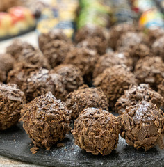 chocolate truffle on black plate