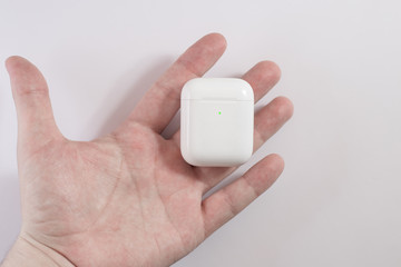 white wireless headphones on background