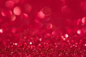Glitter, sparkle defocused blurred red background with bokeh lights
