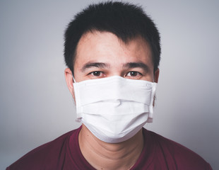 COVID 19 Pandemic Coronavirus protective spreading disease virus by mask ; Man wearing face white...