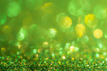 Obraz premium Glitter, sparkle defocused blurred green background with bokeh lights