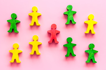 Tolerance, human rights, anti-discrination concept. Wooden figures of people on pink table, top view