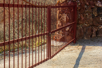 the old locked red gate with bars