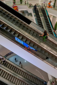Large intersection of escalators inside a large, modern multi-storey mall in an eastern metropolis, Bangkok, Thailand