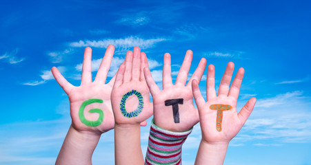 Children Hands Building Colorful German Word Gott Means God. Blue Sky As Background