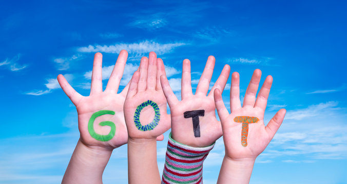 Children Hands Building Colorful German Word Gott Means God. Blue Sky As Background