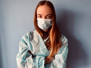 a teenage girl weraing medical clothes pretending to be a doctor during corona virus quarantine time