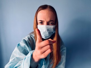 a teenage girl weraing medical clothes pretending to be a doctor during corona virus quarantine time