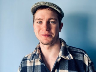 portrait of a handsome young man in a retro cap and shirt