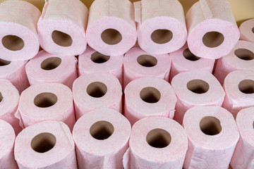 Lots of toilet paper rolls. soft hygienic paper. Pink toilet paper close up