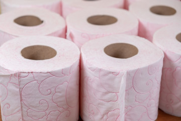 Lots of toilet paper rolls. soft hygienic paper. Pink toilet paper close up