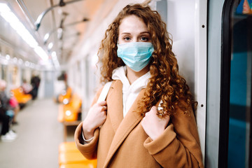 Girl in protective sterile medical mask in the subway car. Woman, wear face mask, protect from...