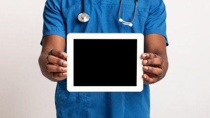 Empty digital tablet screen in black doctor hands