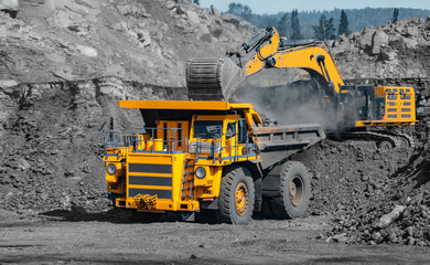 Coal loading at open mining site yellow truck industry