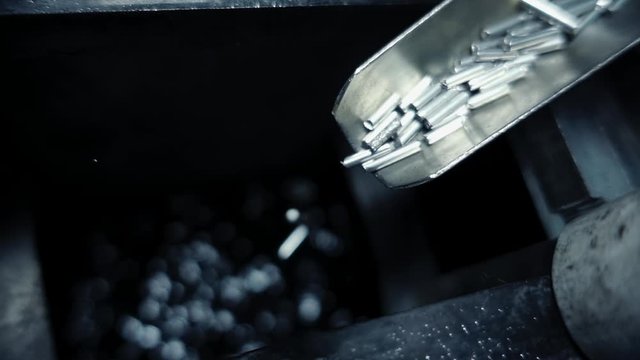 Silver Tubes Are Falling Down into Water, Black Background, Metallurgy, High Angle
