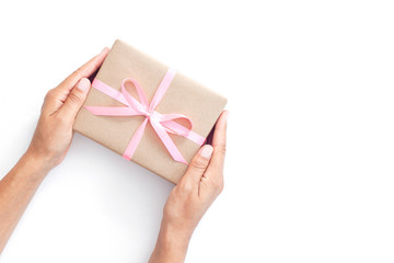 Female hands holding present box or gift box package in craft pa