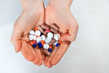 A lot of colorful medication and pills in hands from above. Taking Your Medication