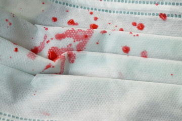 close up of blood from cough patient on hygienic mask for protection nose and mouth