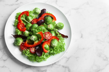 Tasty salad with Brussels sprouts on white marble table, top view. Space for text