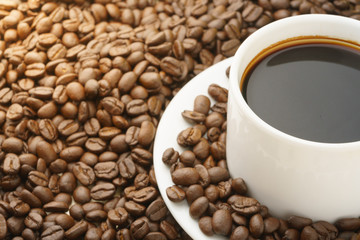 close up on coffee cup with coffee beans. free copy space for your text