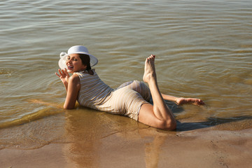 Woman in retro swimsuit posing at the beach
