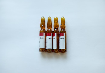 four brown ampoules on a white background