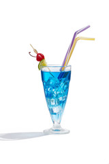 Blue Lagoon cocktail with ice cubes is contained in a milkshake glass with two straws, a lime slice and a cherry on the stick. The showy illustrative picture is made on the white background.