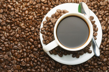 top view of coffee cup with coffee beans and steel spoon. flat lay. free copy space for your text