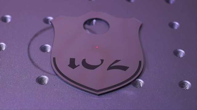 Engraving of a plastic wardrobe number on a laser engraver