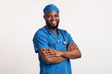 Young black medical doctor smiling over white background