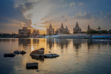 Obraz premium Sunset view of chhatri or canopies at Orchha from across the betwa river in Orchha Madhya Pradesh India.