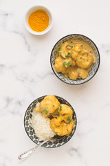 Two bowl full of vegan curry. White background