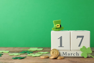 Composition with block calendar on wooden table, space for text. St. Patrick's Day celebration