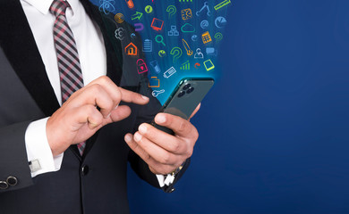 Professional man using smart mobile phone with app icons floating around