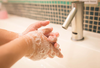 Closeup woman washing hand with soap for coronavirus protection,