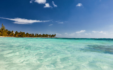 Naklejka na ściany i meble Tropical island. View of the beach from the water.