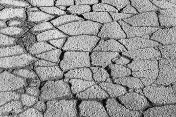 Texture of gray cracked asphalt. Abstract background for design.