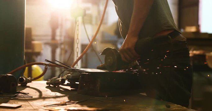 Bladesmith working with angle grinder