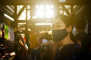 The Asian woman portrait travelling in Bangkok , Thailand by wearing the preventive mask on her face to protect her self from any illness especially Covid 19 or Corona virus spreading around the world