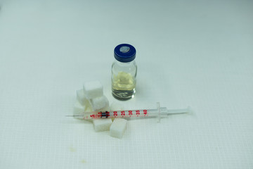 Syringes for insulin on the background of sugar cubes. Diabetes Vaccine