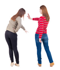 Back view of two pointing girl in sweater.