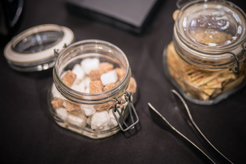 Cubes of brown sugar in the glass jar,closeup