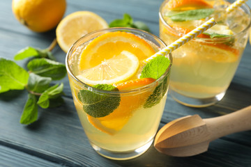 Glasses with lemonade on wooden background, close up