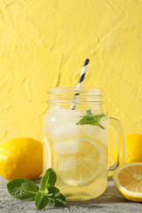 Lemonade, lemons and mint on grey table. Fresh drink