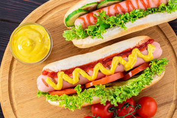 Hot dogs on wooden background. Top view, food flat lay. Fast food concept