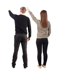 Back view of couple in sweater pointing.