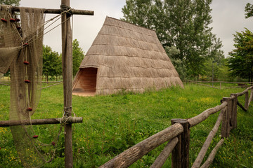 Fototapeta na wymiar Traditional fisherman's house, covered with reed, located in the Caorle lagoon