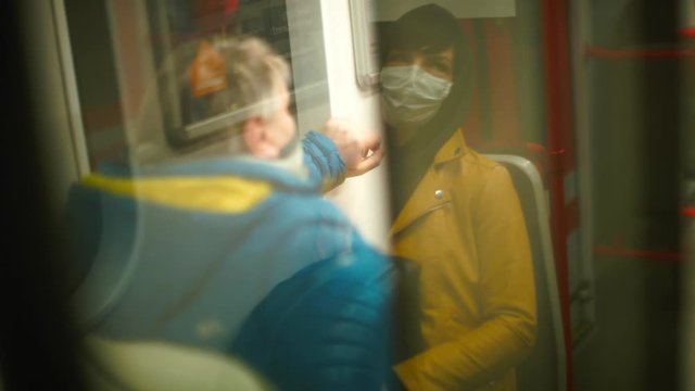 A masked passenger using public transport during an outbreak of an infectious disease COVID-19. Social distancing as a precaution, increased risk. 