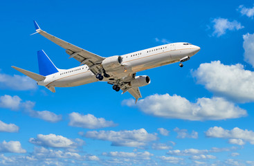 Fototapeta na wymiar Airplane on cloudy blue sky background including clipping path
