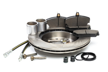 brake parts on white: brake pads, disc, brake hose, guides, cylinders .